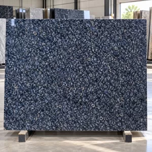 Honey Blue Granite polished slab with dark blue-grey base and fine mineral speckles