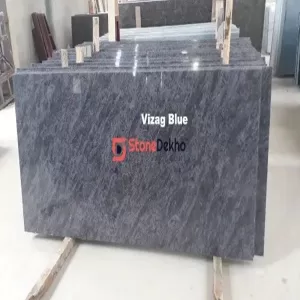 Vizag Blue Granite polished slabs with blue-grey wave pattern in stone warehouse