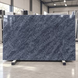 Vizag Blue Granite polished slab in showroom with blue-grey wave pattern